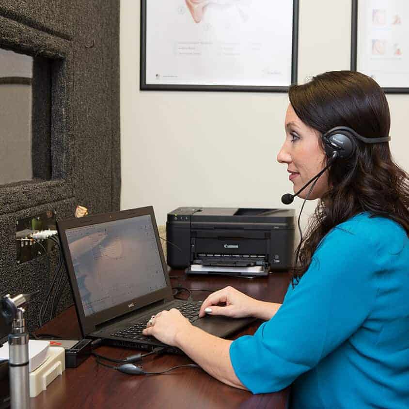 Candace Wawra performing a hearing test