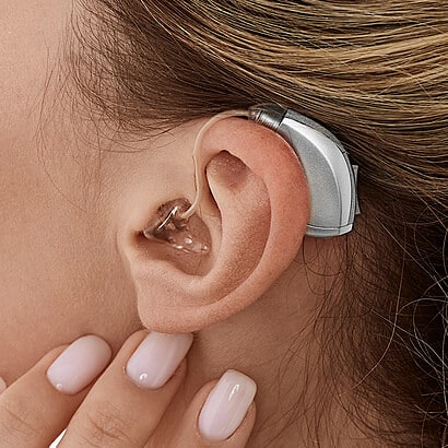BTE hearing aid in woman's ear